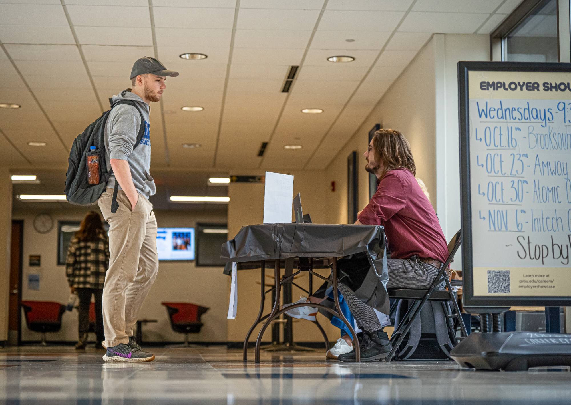 student talking to employer